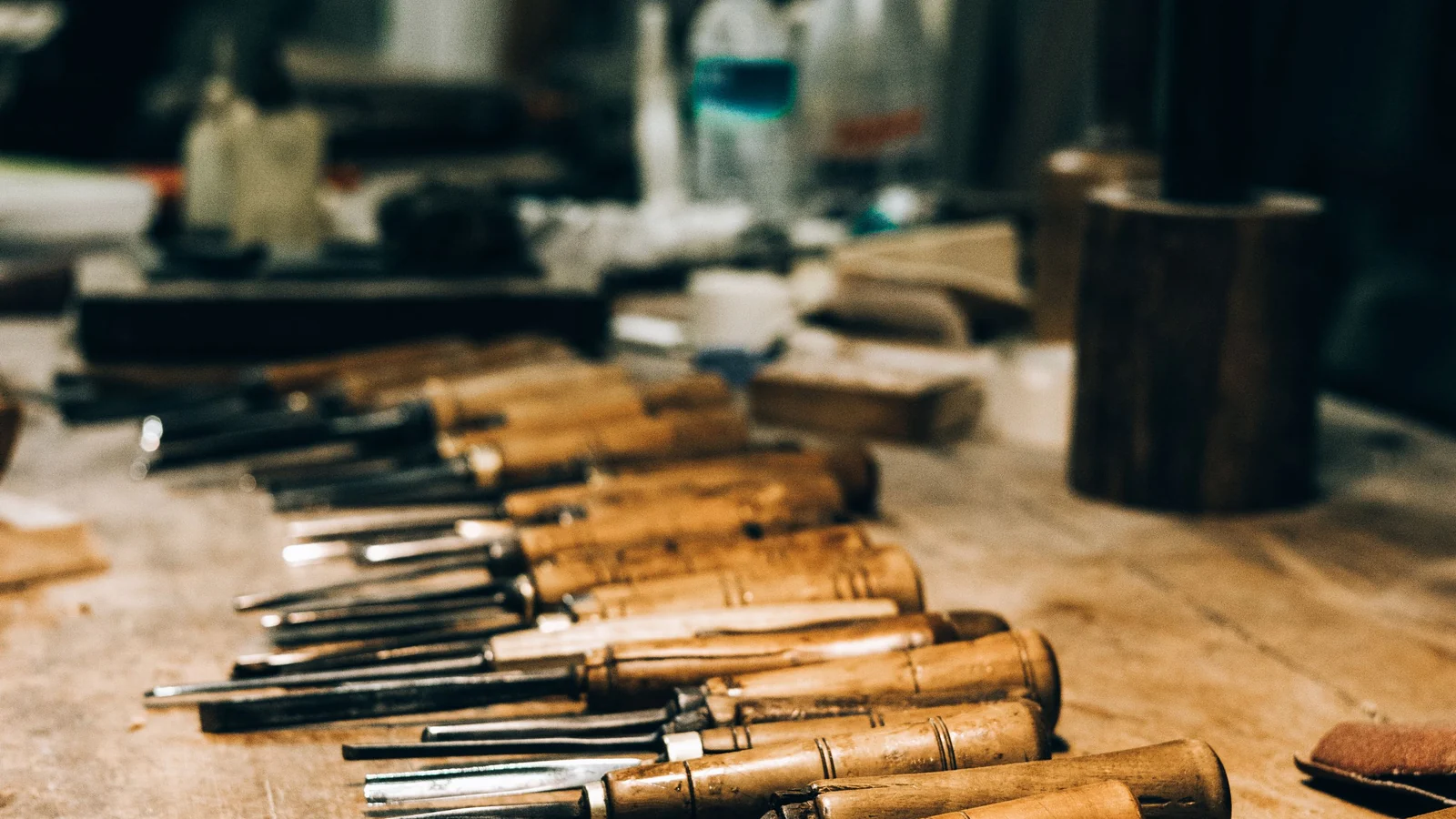 Carving chisels lined up on a workbench