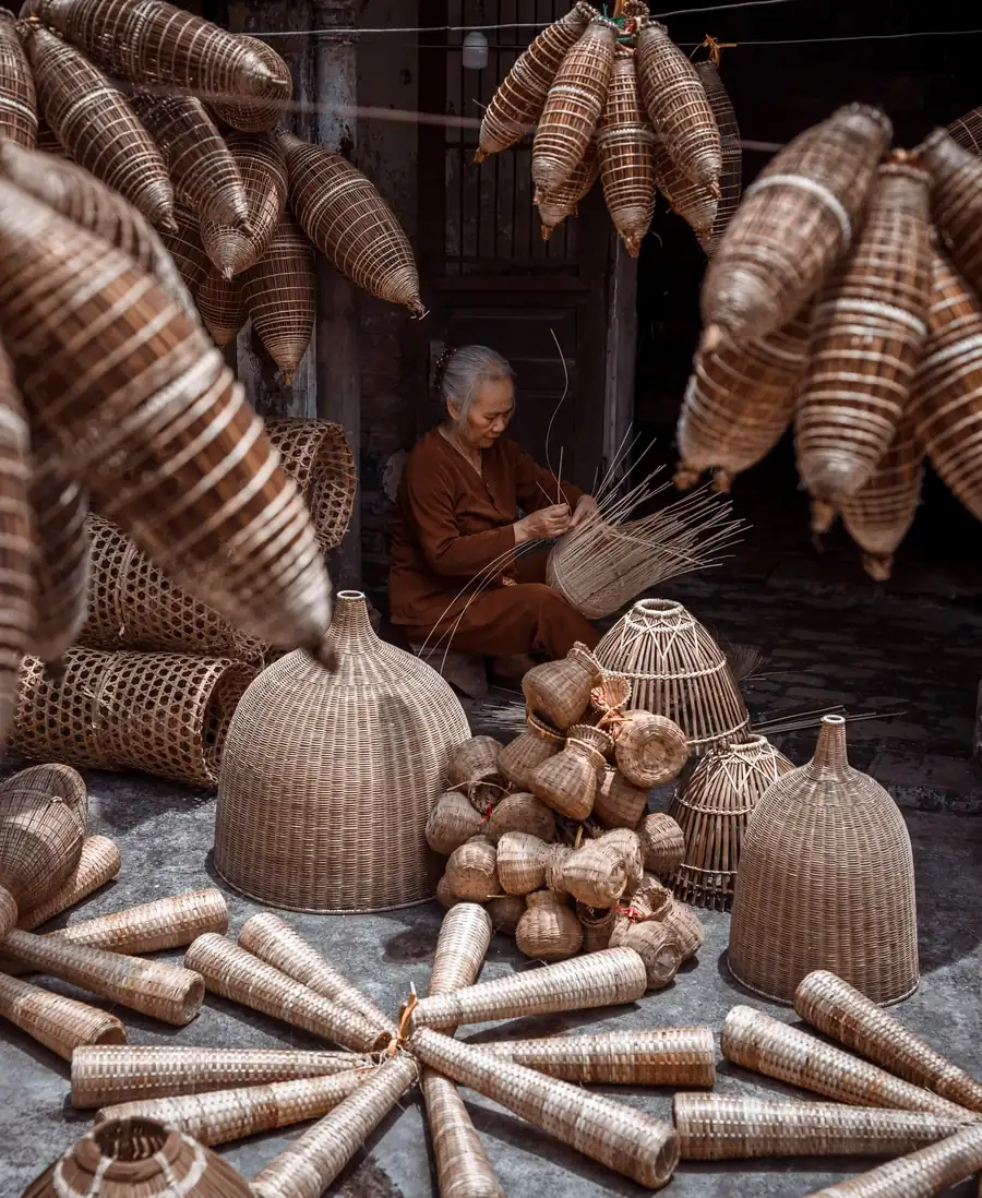 Hand-woven baskets hanging in an open workshop